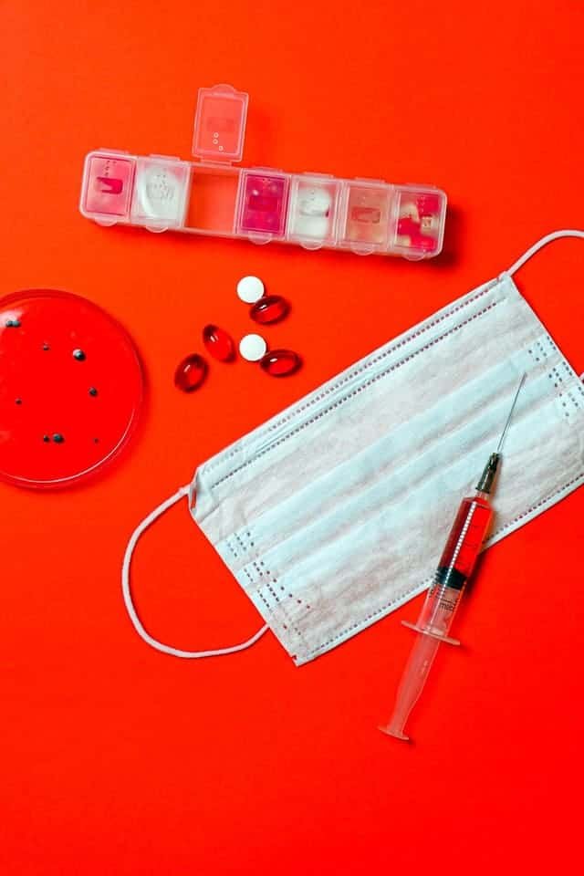 Syringe and pills with petri dish